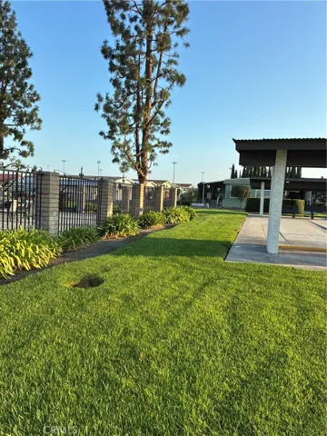 Next to pool grassy picnic tables