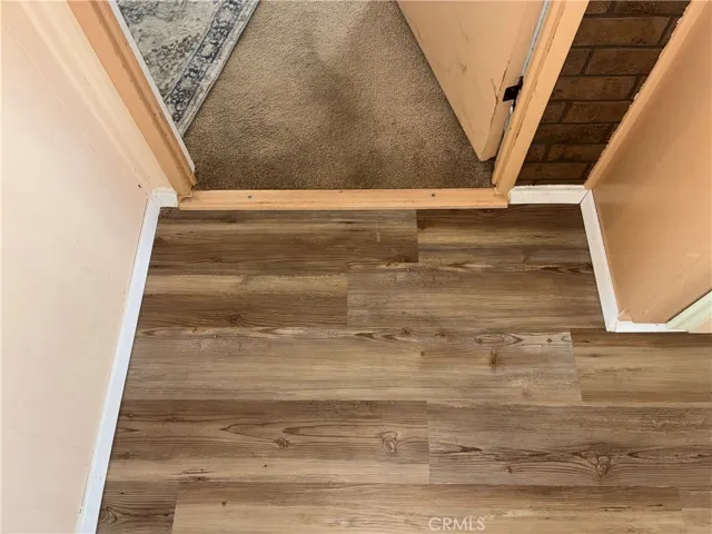 new wood flooring and new wood threshold dining room to primary bedroom