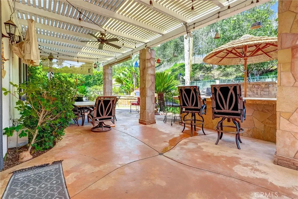 shaded awning area backyard with custom outdoor lighting.