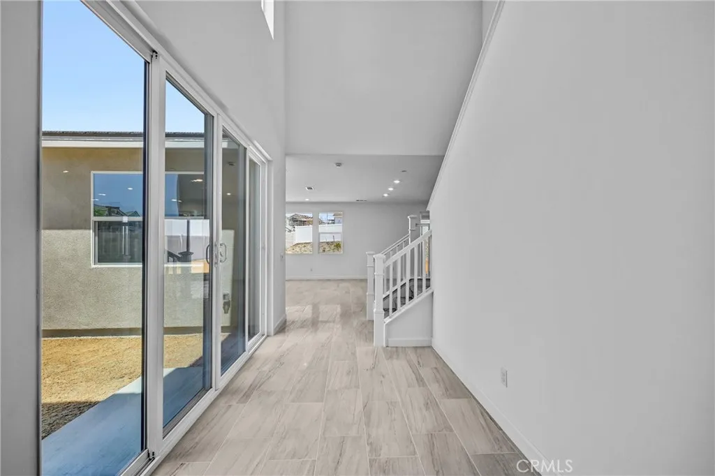 Walkway to kitchen / family room with large slider to backyard Walkway to kitchen / family room with large slider to backyard