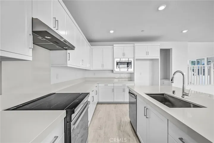 White kitchen with stainless steel appliances