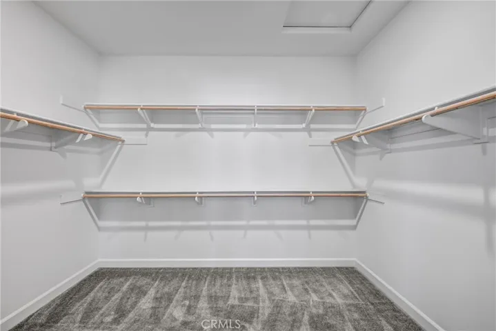 Primary bedroom walk in closet