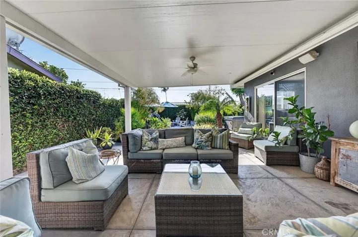 Lounge area leads to a fire pit and above ground spa.