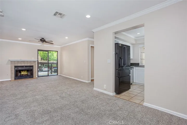Spacious living room with fireplace and access to balcony/deck.