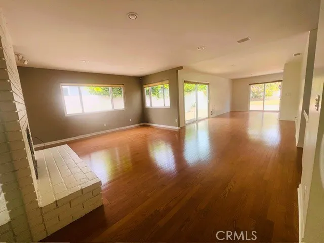 Living room looking toward dining area and back and side yards