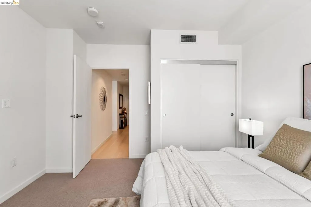 Bedroom featuring wall-to-wall carpeting, white walls, and an open doorway
