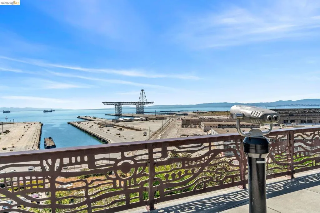 Expansive water scenery with distant ships and industrial structures