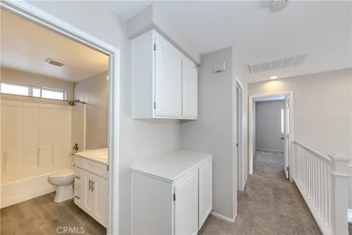 Hallway leading to secondary bedrooms and shared bathroom