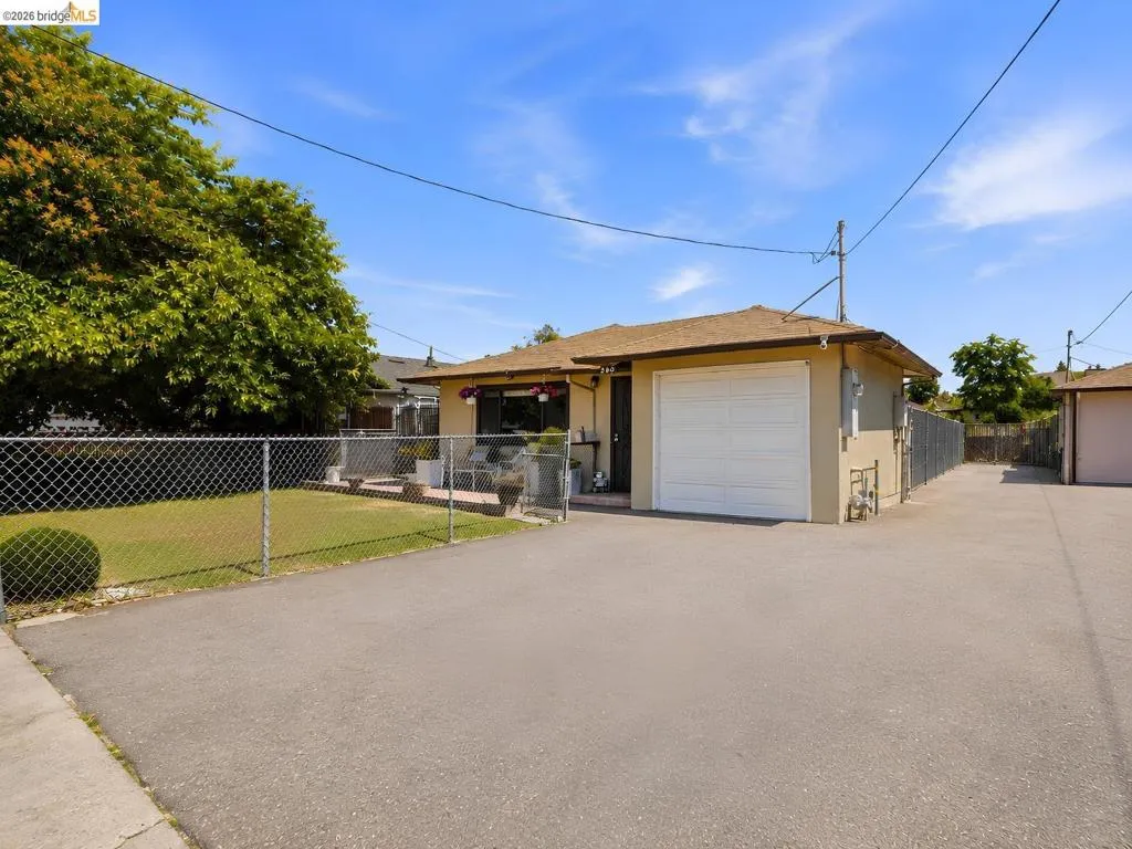 Paved driveway leading to an attached garage with a white door