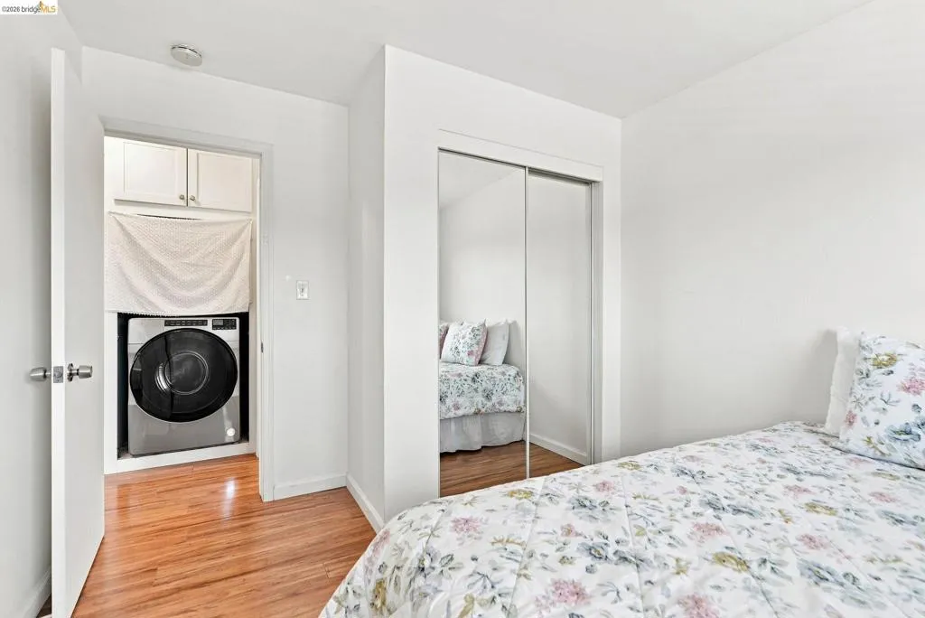 Hardwood-finish flooring, built-in mirrored closet, and an in-unit washer