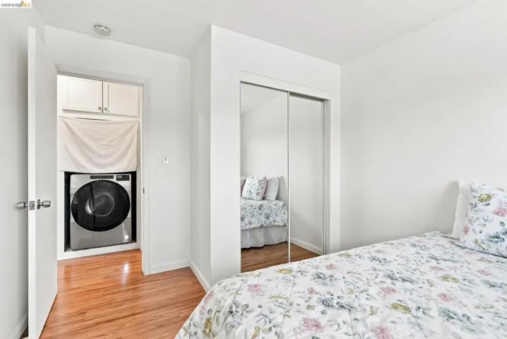 Hardwood-finish flooring, built-in mirrored closet, and an in-unit washer