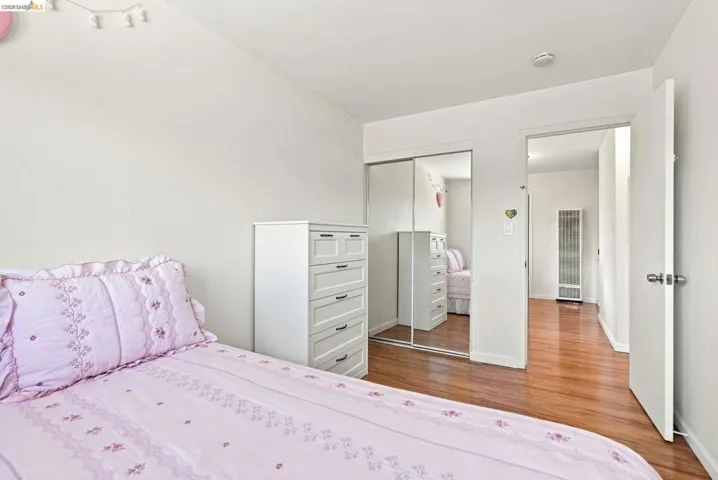 Hardwood-style flooring throughout, mirrored closet doors, and recessed lighting