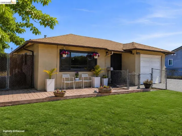 Stucco exterior with a shingle roof, integrated single-car garage, and a brick paver walkway