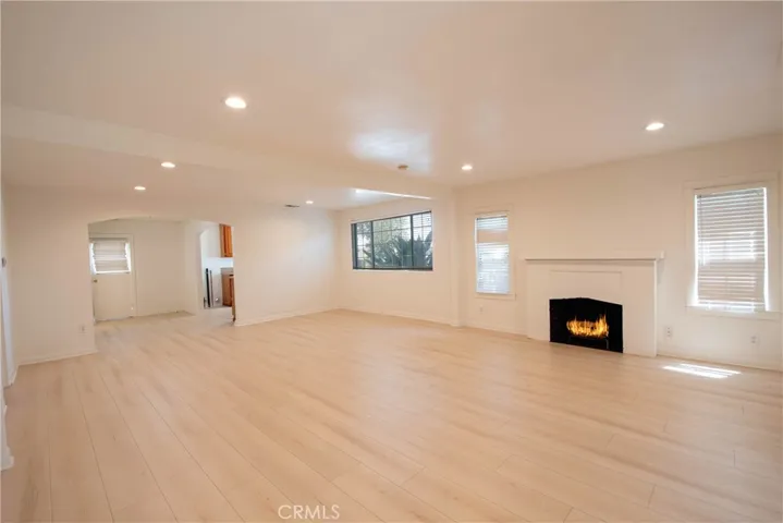Light-filled living room featuring new flooring and fresh interior paint.