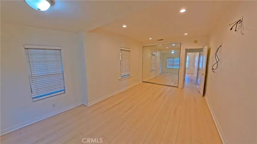 Spacious primary suite created by combining two original bedrooms.