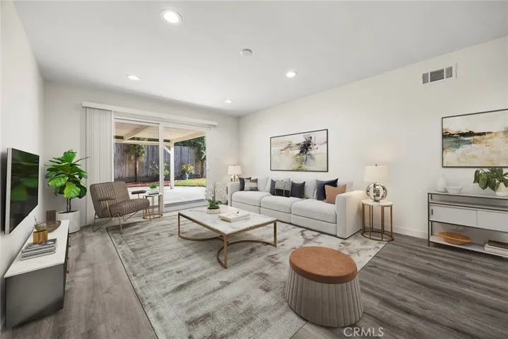 Digitally staged family room off of kitchen
