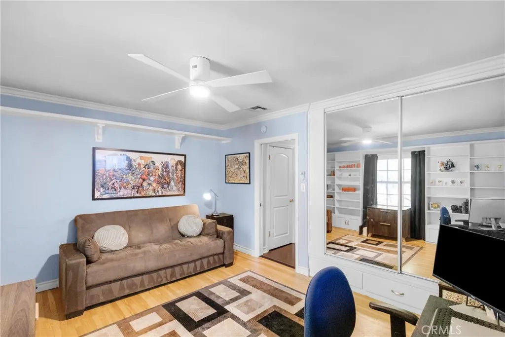 Bedroom three features beautiful floors and a ceiling fan