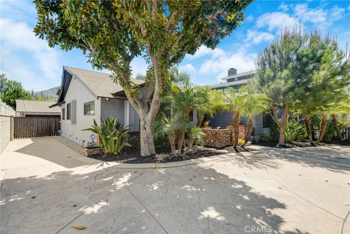 Semi-circlular driveway along with side driveway into back detached garage