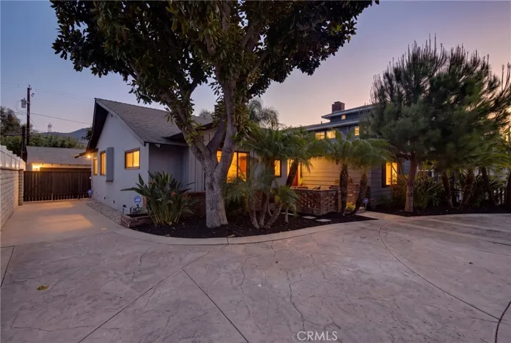 Semi-circlular driveway along with side driveway into back detached garage, digitally enhanced