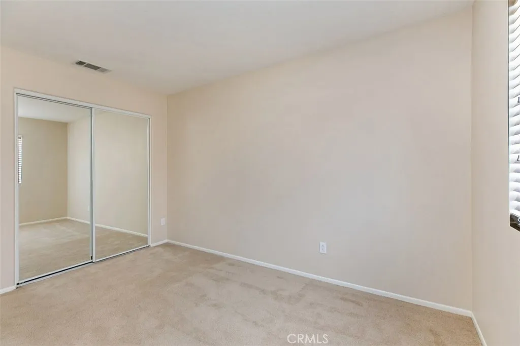 Third bedroom, with mirrored closet and wood-blind shades. *flooring to be updated with LVP prior to move-in. Third bedroom, with mirrored closet and wood-blind shades. *flooring to be updated with LVP prior to move-in.