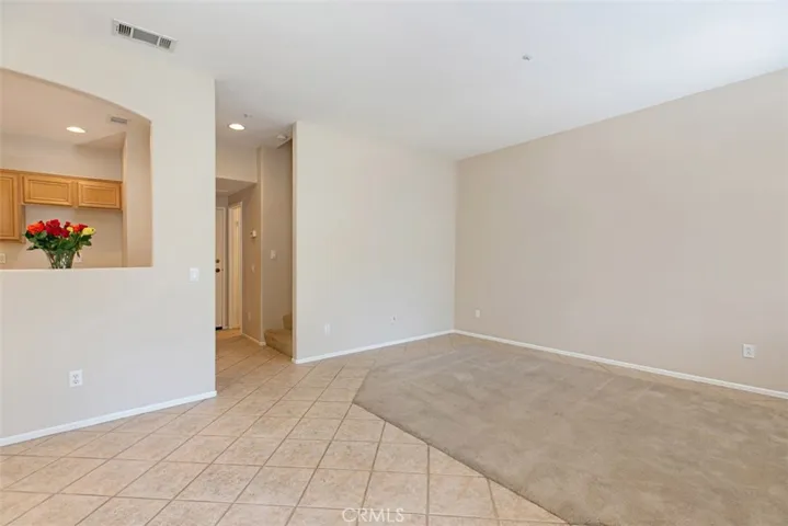 Downstairs common area. Living room and dining space. *flooring to be updated with LVP prior to move-in.
