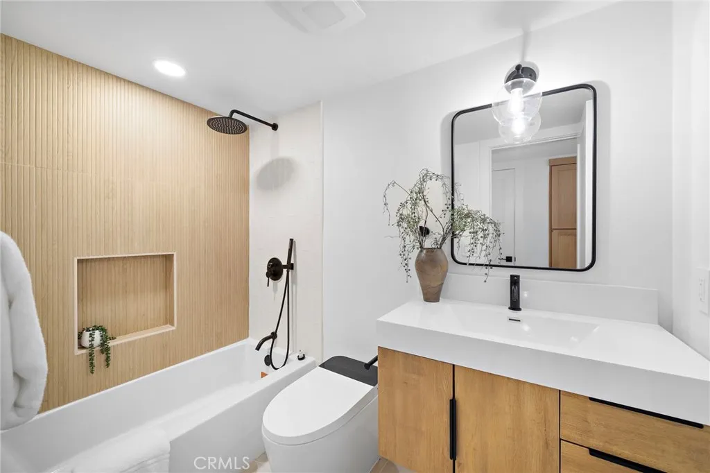 3 bedrooms and 2 baths are located on the main level, including the primary suite with 2 closets, sliders to backyard, and a luxurious Marble ensuite w/custom beadboard dual-sink vanity, and oversized shower w/multiple showerheads & frameless glass enclosure.
