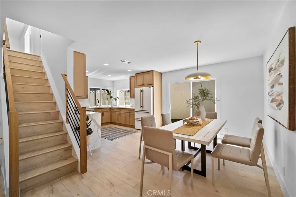 The elegant living room is highlighted by a striking natural stone fireplace, while the heart of the home is the showstopping chef-inspired kitchen, open to the spacious dining area w/sliders leading to the wide side yard and covered patio.