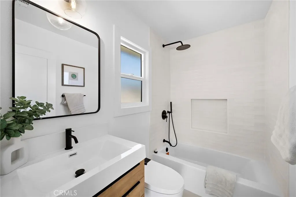 3 bedrooms and 2 baths are located on the main level, including the primary suite with 2 closets, sliders to backyard, and a luxurious Marble ensuite w/custom beadboard dual-sink vanity, and oversized shower w/multiple showerheads & frameless glass enclosure.