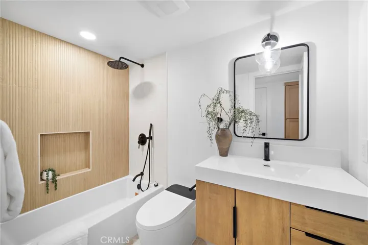 3 bedrooms and 2 baths are located on the main level, including the primary suite with 2 closets, sliders to backyard, and a luxurious Marble ensuite w/custom beadboard dual-sink vanity, and oversized shower w/multiple showerheads & frameless glass enclosure.