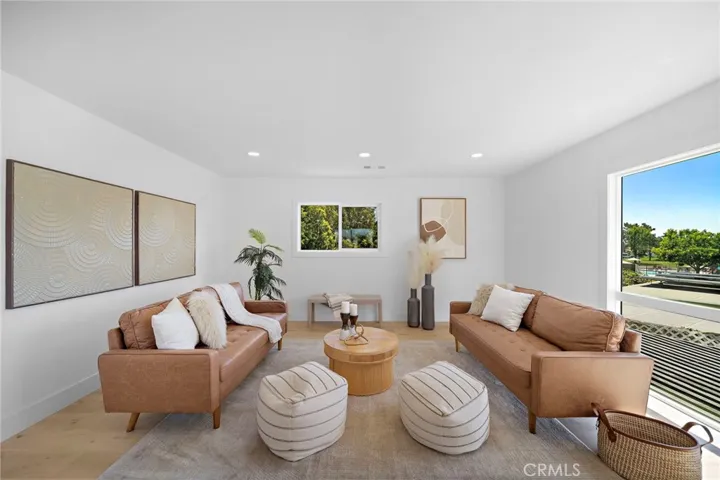 3 bedrooms and 2 baths are located on the main level, including the primary suite with 2 closets, sliders to backyard, and a luxurious Marble ensuite w/custom beadboard dual-sink vanity, and oversized shower w/multiple showerheads & frameless glass enclosure.