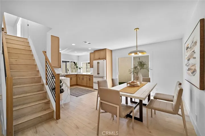 The elegant living room is highlighted by a striking natural stone fireplace, while the heart of the home is the showstopping chef-inspired kitchen, open to the spacious dining area w/sliders leading to the wide side yard and covered patio.