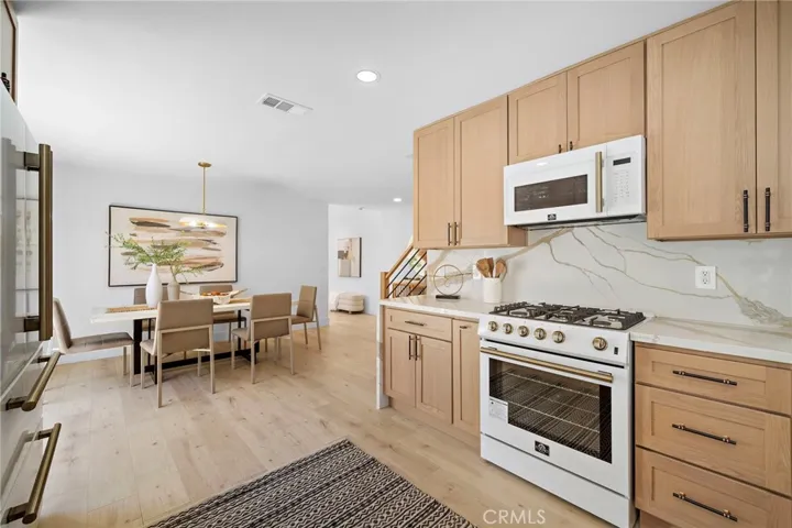 Gorgeous Chef's kitchen with Quartz countertops open to dining area