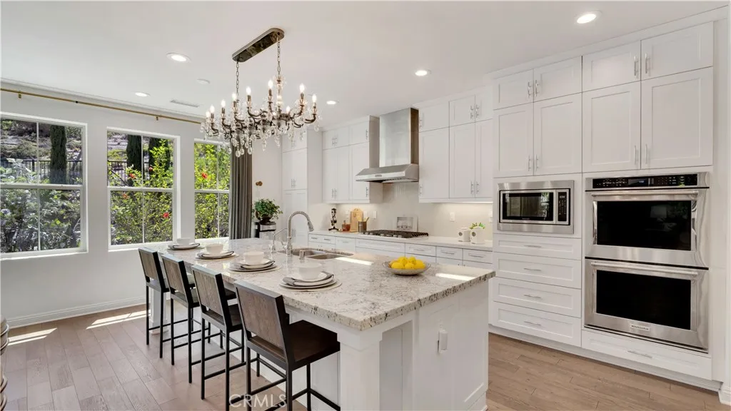 Kitchen with expansive center island and abundant cabinetry Kitchen with expansive center island and abundant cabinetry