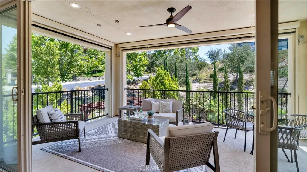 Private outdoor living area directly off the primary bedroom, featuring retractable screens Private outdoor living area directly off the primary bedroom, featuring retractable screens