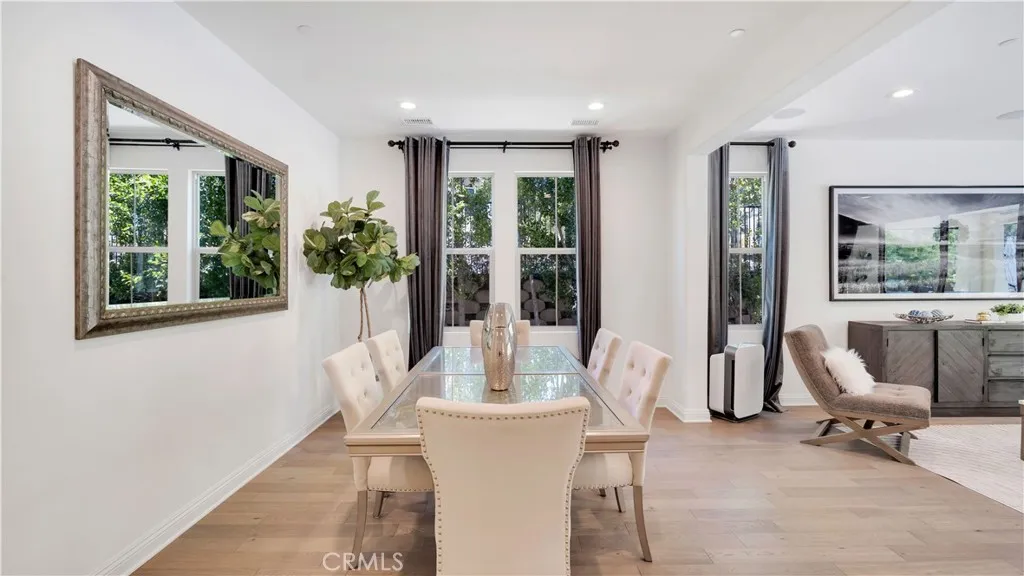Dining area with kitchen and staircase view Dining area with kitchen and staircase view