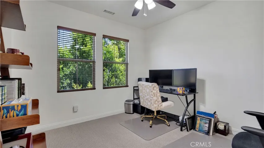 fourth bedroom currently styled as a home office, offering flexible use
