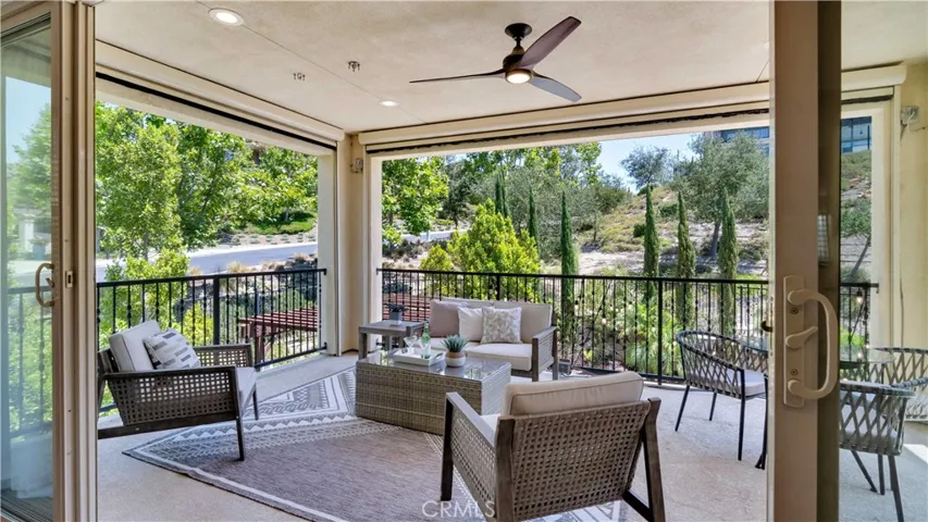 Private outdoor living area directly off the primary bedroom, featuring retractable screens