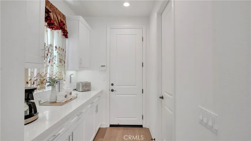 Convenient transition area between the kitchen and garage with built-in storage and counter space