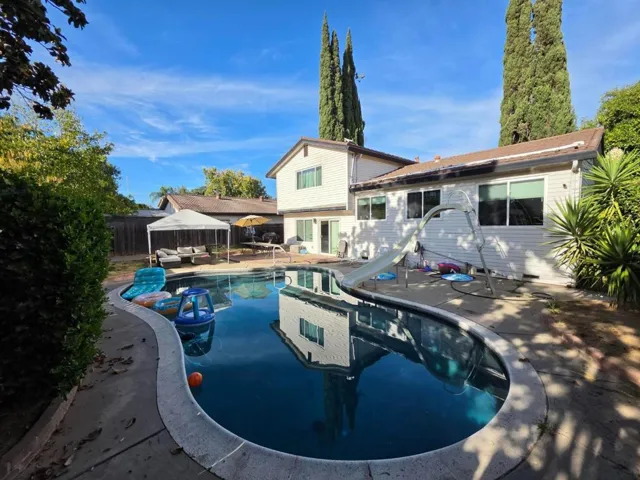 Large backyard with seating patio and pool 3016 Bettina Way