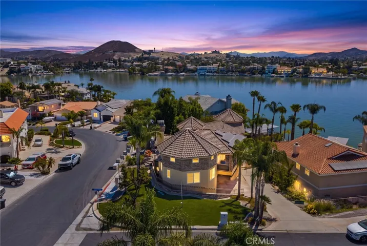Exceptional curb appeal and incredible lake views from this custom built, corner lot home