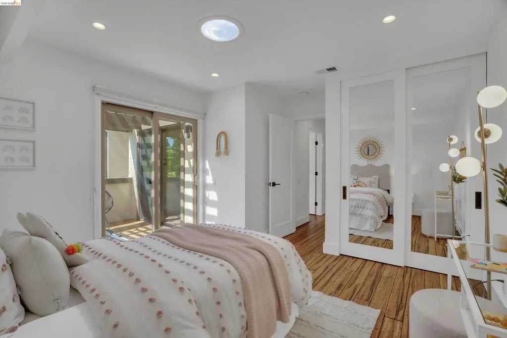 Recessed lighting and a circular skylight illuminate this space with wood-finish flooring
