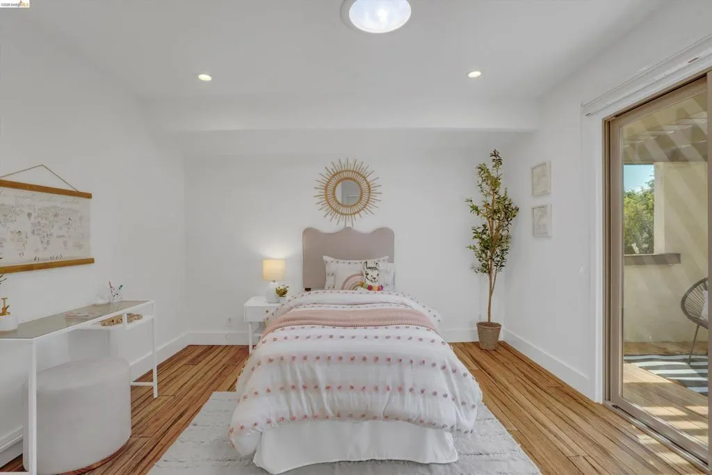 Wood-finish flooring, recessed lighting, ceiling light fixture, white baseboards, and sliding glass door
