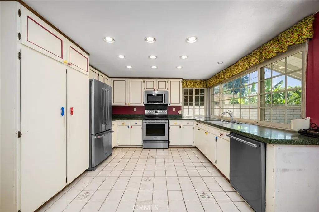 Kitchen houses Frigidaire Professional Series microwave, electric range, and dishwasher.