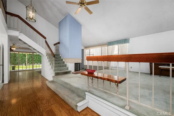 Entry with vaulted ceiling and wood flooring.