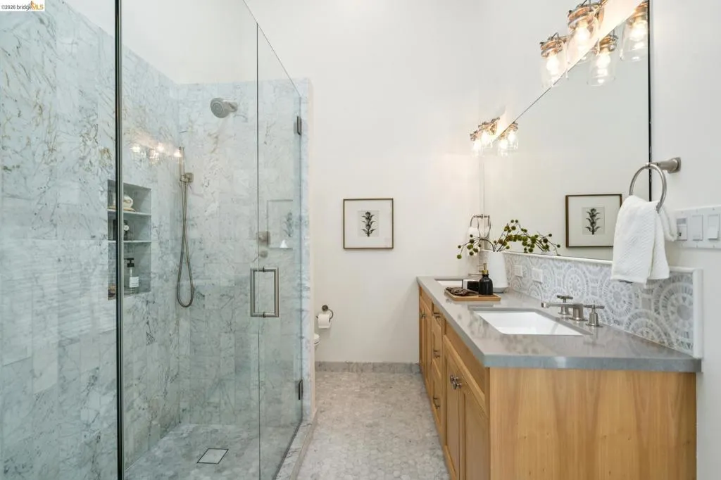 Glass-enclosed shower with full-height stone-finish tiling and dual built-in niches Glass-enclosed shower with full-height stone-finish tiling and dual built-in niches