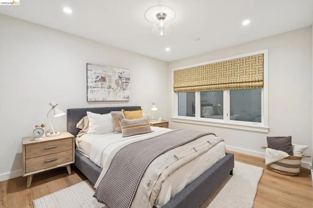 Recessed lighting, wood-finish flooring, and a large window with custom treatments Recessed lighting, wood-finish flooring, and a large window with custom treatments