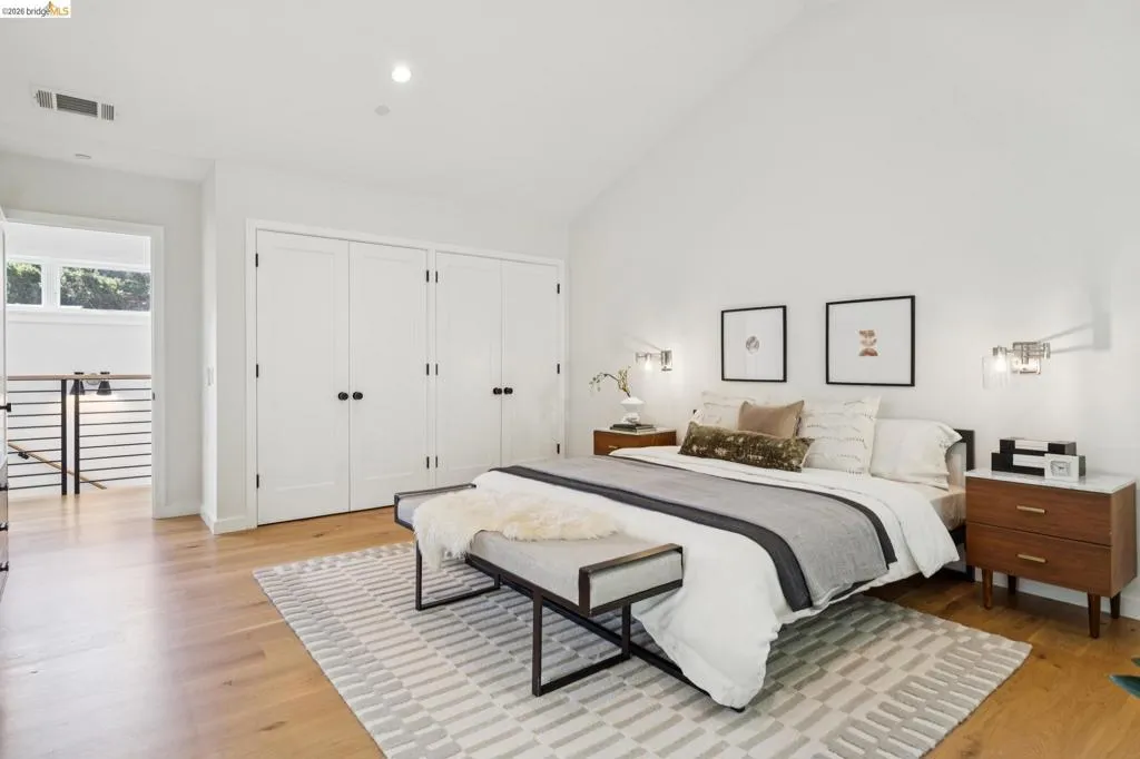 Vaulted ceiling, recessed lighting, wood-finish flooring, built-in wardrobe, and integrated wall sconces Vaulted ceiling, recessed lighting, wood-finish flooring, built-in wardrobe, and integrated wall sconces