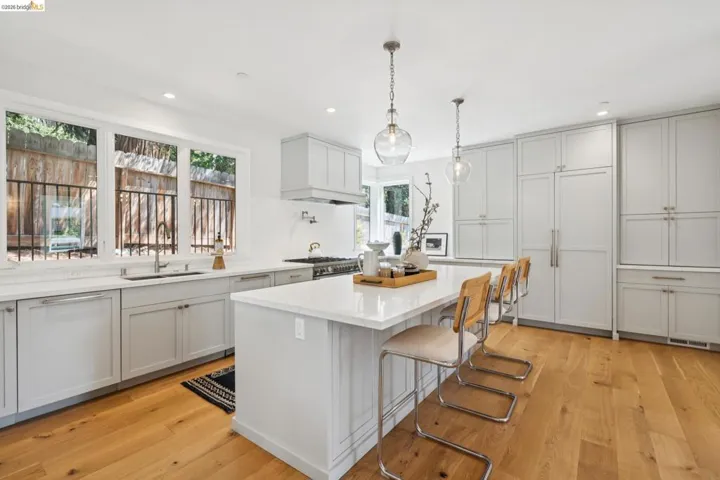 Light wood-finish flooring with white walls