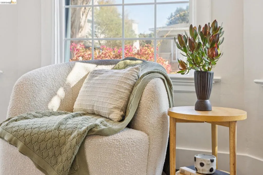 White interior walls with a large window featuring mullions