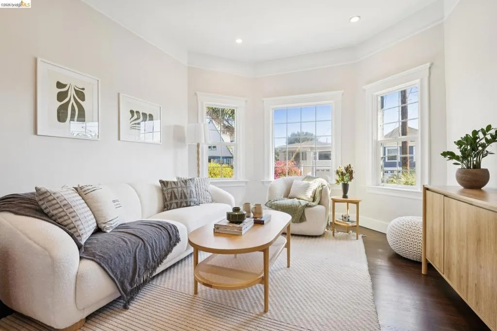 Bay window with multiple large pane windows, dark wood-finish flooring, recessed lighting, and crown molding